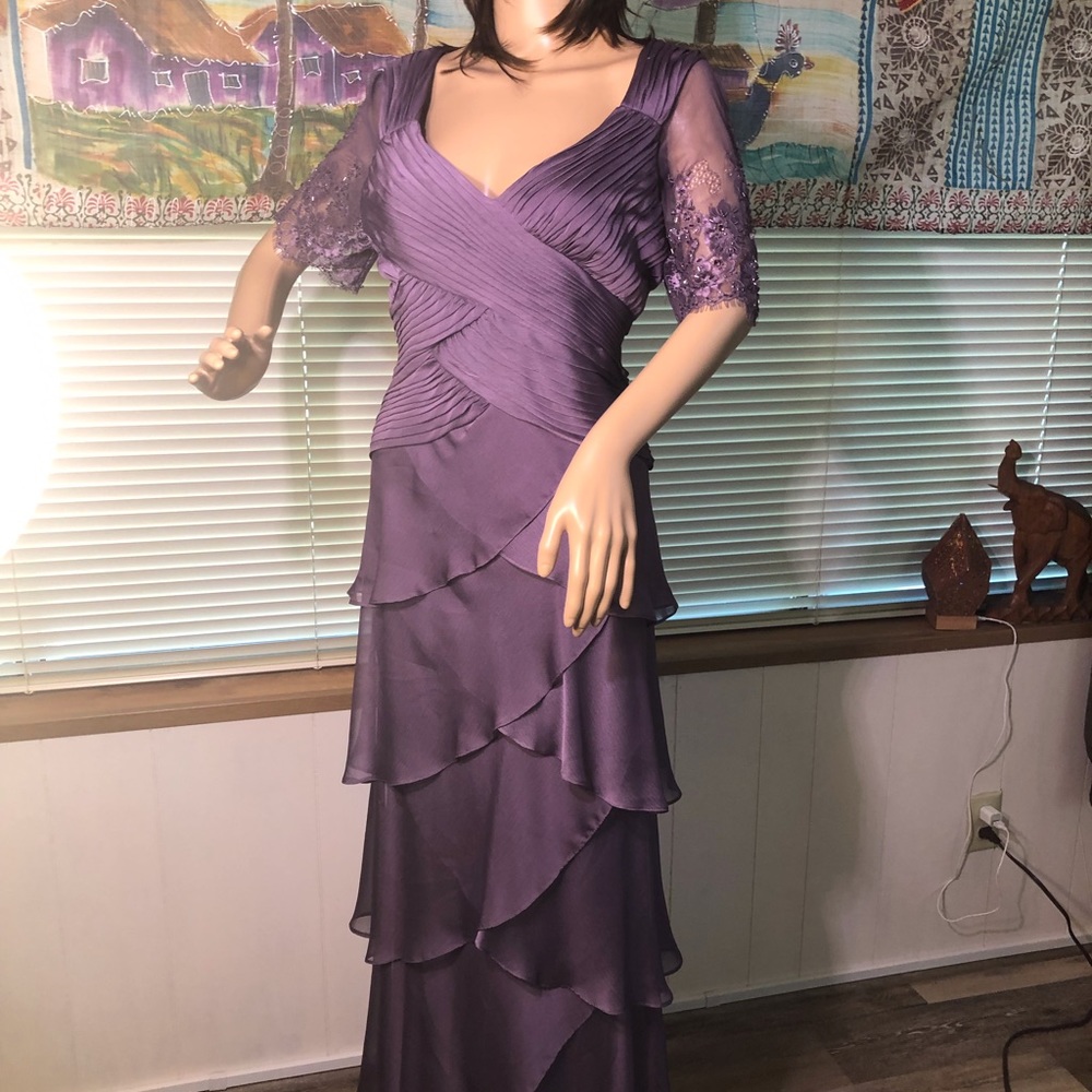 This is a beautiful plum colored evening gown by Adriana Papel.